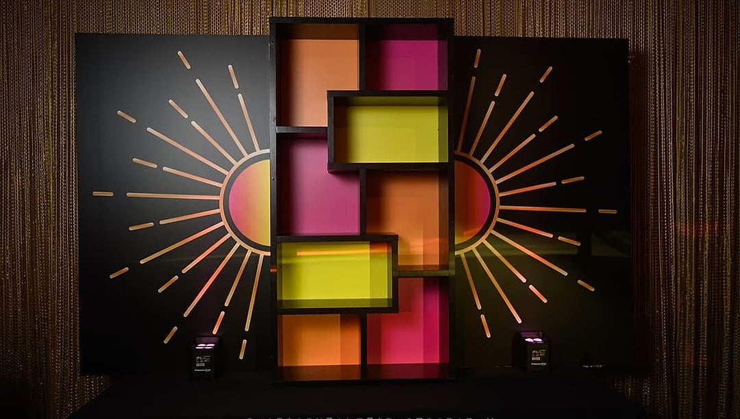 Sunburst-themed backdrop of colorful glowing panels
